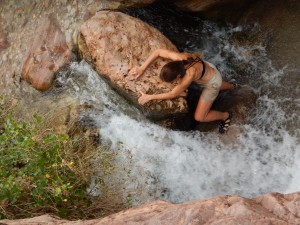 Yvonne climbing up waterfall